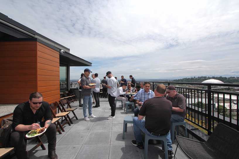 A celebratory lunch hosted by Isola Homes is enjoyed on the AV Lofts rooftop deck.