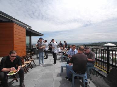 A celebratory lunch hosted by Isola Homes is enjoyed on the AV Lofts rooftop deck.