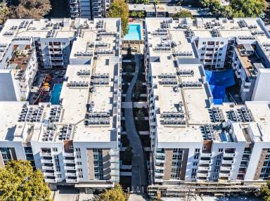 Aerial view of two mirrored residential apartment buildings.