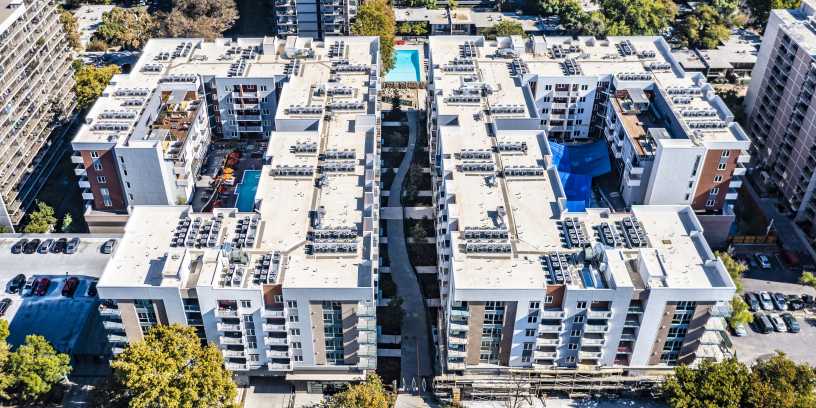 Aerial view of two mirrored residential apartment buildings.